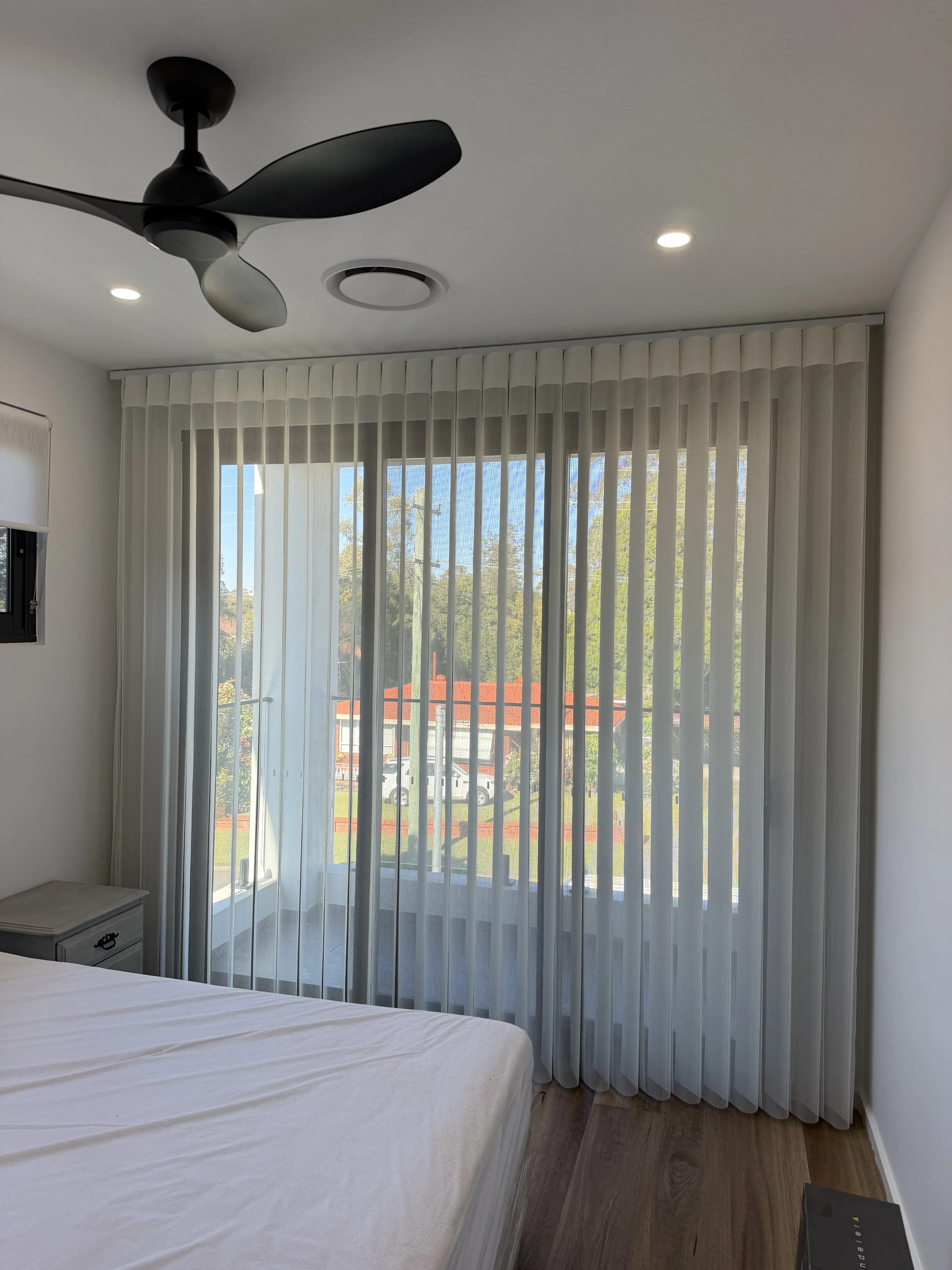 Layered sheer and blockout curtains in a Sydney home